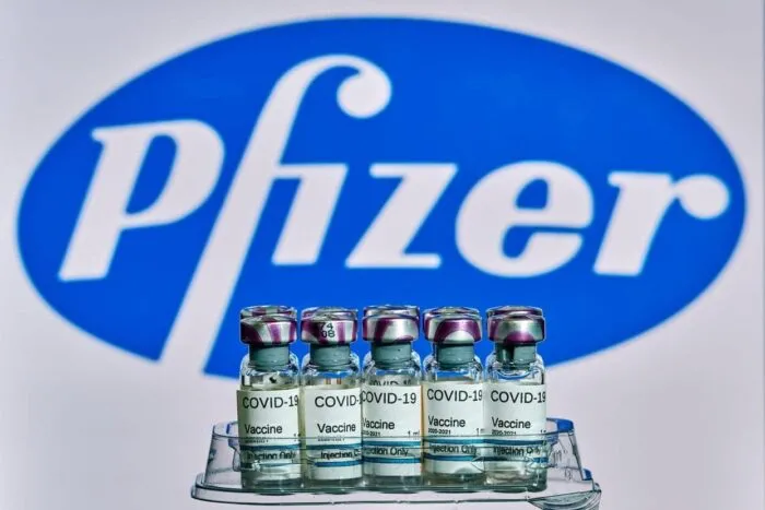 MALLORCA/ESPAA- November 13 2020: Pfizer Biontech research Coronavirus (Covid 19) vaccine. Row of vaccine bottles with blurred Pfizer company logo on