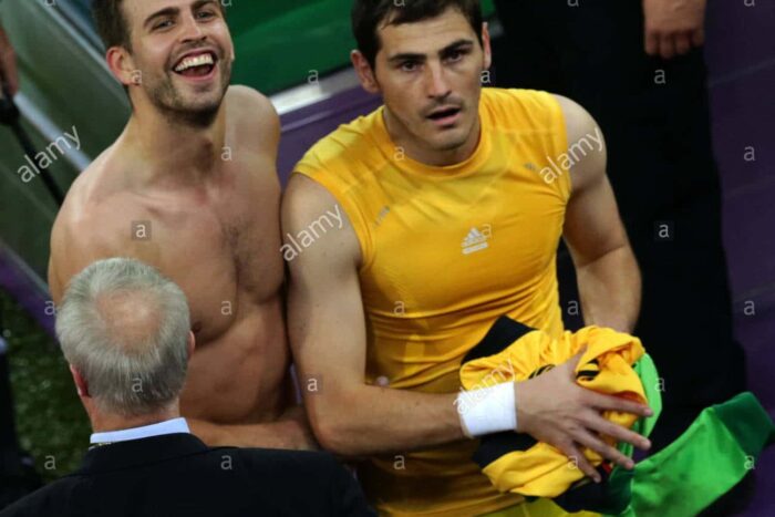 spains goalkeeper iker casillas r and gerard pique l celebrates after D65EX4
