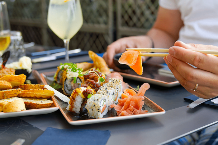 eating sushi with chopsticks at sushi restaurant 2022 11 09 15 59 49 utc 1