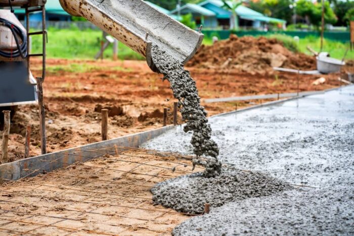 Construction,Workers,Supervise,The,Pouring,Of,Concrete,On,The,Construction