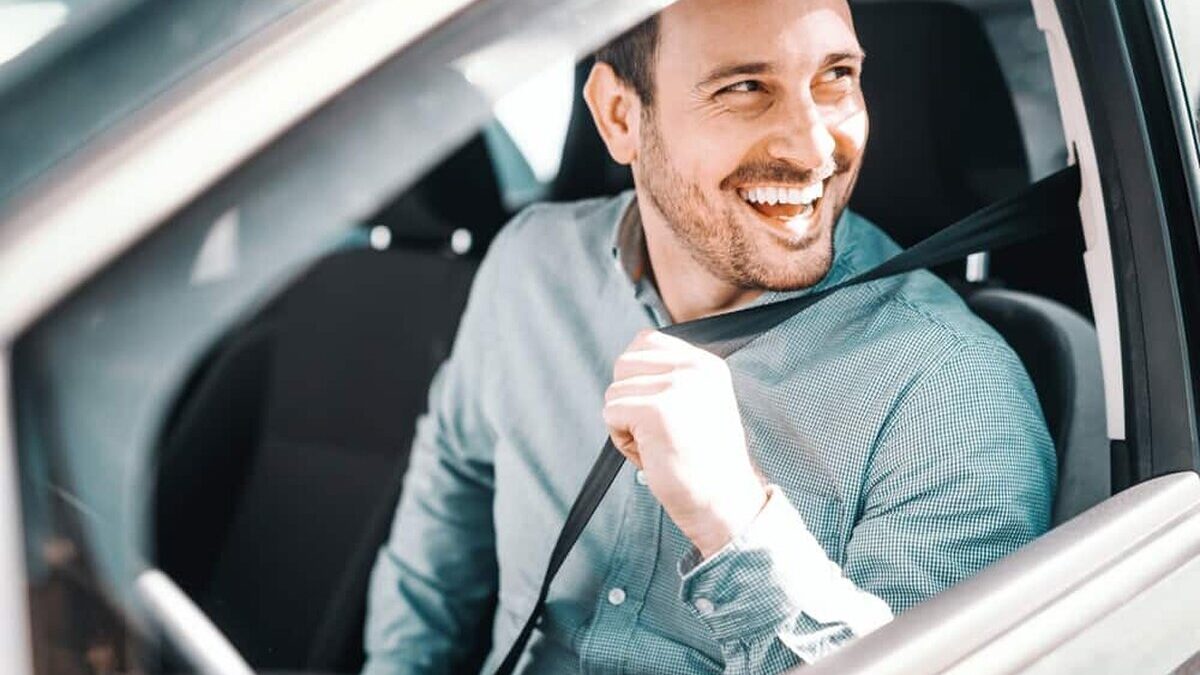 Portrait,Of,Smiling,Caucasian,Man,Fastening,Seat,Belt,And,Sitting