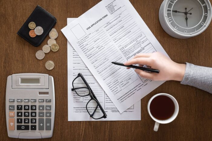 visa application form wooden table visa processing registration flat lay min scaled