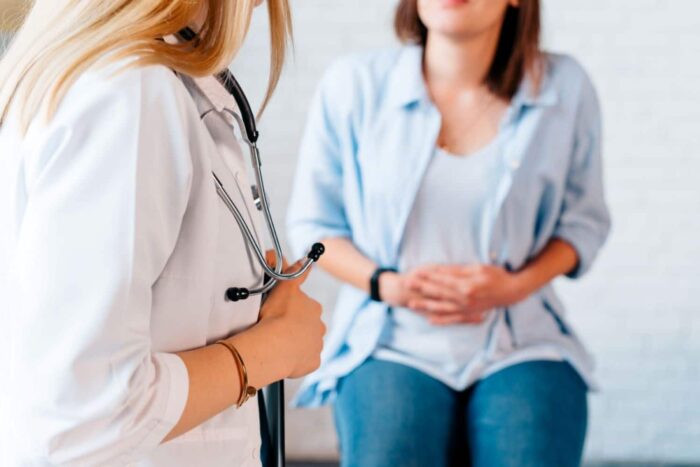 female-patient-with-abdominal-pain-caused-by-stomach-cancer-examined-by-female-specialist
