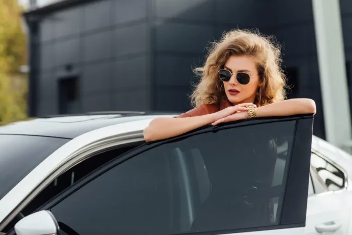 confident-woman-formal-dress-outdoors-posing-near-her-white-car.jpg