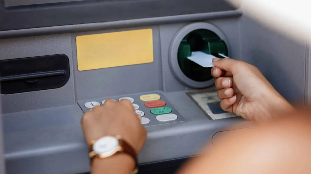 closeup-woman-typing-pin-code-while-withdrawing-money-from-atm-scaled.jpg