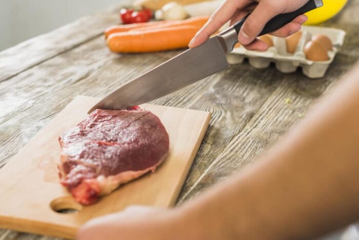 chef kitchen cutting meat 1024x731