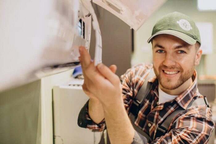 repairman doing air conditioner service 1024x683