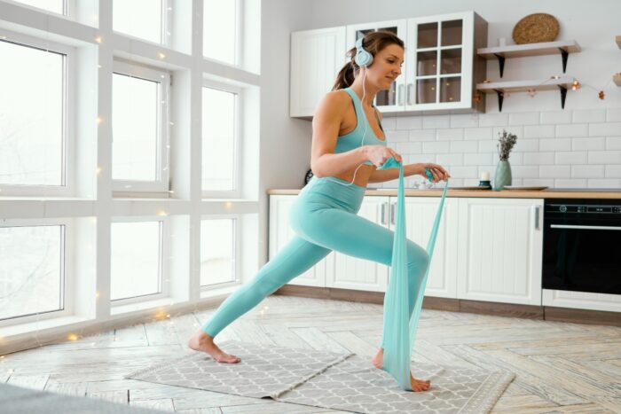 woman exercising mat with elastic band 1