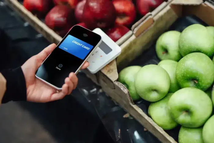 making contactless payment with smart phone at farmers market stock photo.webp