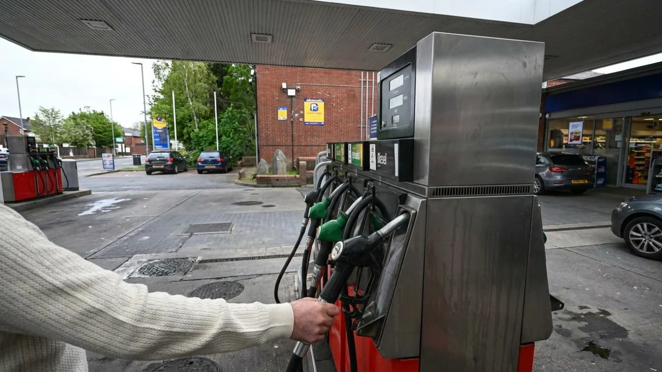 Getty Images A person's hand on a petrol pump in a forecourt in a nondescript location in the UK