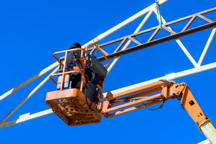 Worker,Is,Using,Lift,To,Install,Metal,Beams,At,Construction