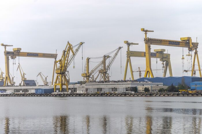 Vedere de ansamblu a utilajelor dintr-un șantier naval de la malul mării